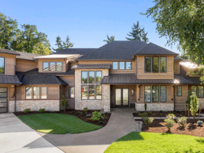 Front of large residence with clean, reflective glass windows.