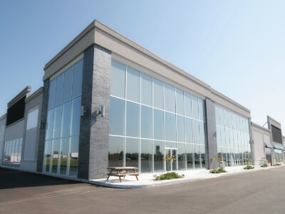 Full glass windows on corner unit of retail shopping center.