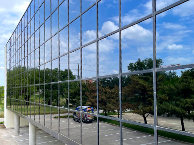 Office building windows reflecting the sky after being cleaned to a spotless shine.