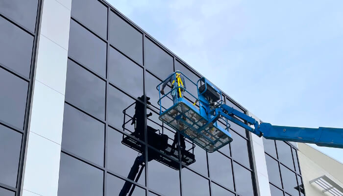 First Glass, Inc. team at work cleaning the windows on a commercial building.