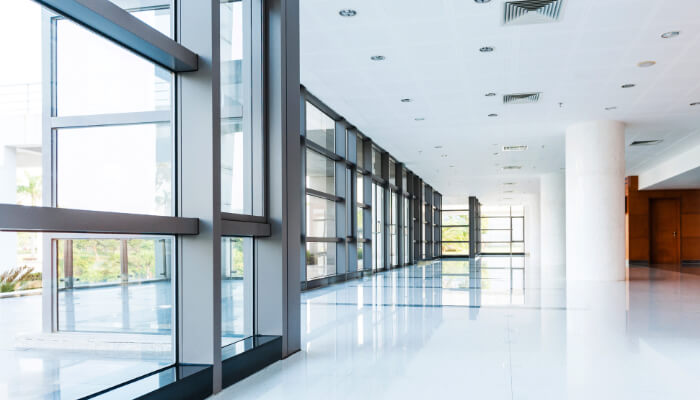 Large windows lining office building ground floor.