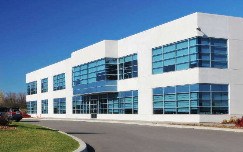 Two story office building with clean, blue tinted windows.